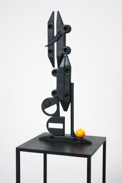 Erik Frydenborg, Structure with Memorized Orange, 2012. Patinated aluminum, synthetic fruit.
79 x 18 x 18 inches.